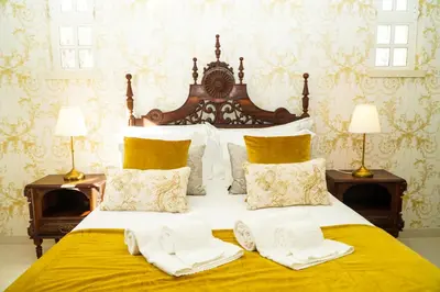 a bedroom with a large bed with two lamps at Seaside Serenity Villa in Albufeira