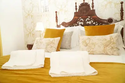 a bed with white blankets and pillows on it at Seaside Serenity Villa in Albufeira