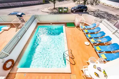 an overhead view of a swimming pool with chairs and a car at Villa Canto in Albufeira