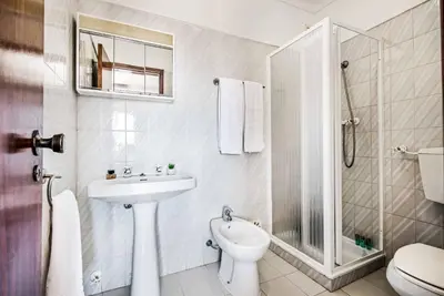 a bathroom with a toilet and a sink and a shower at Villa Canto in Albufeira