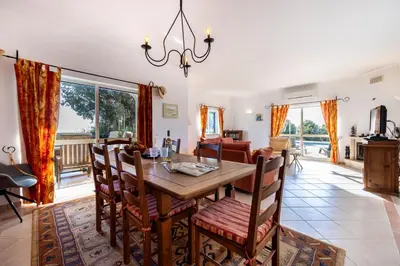 a dining room with a table and chairs at Casa Neel in Boliqueime