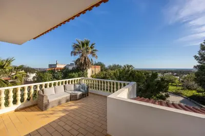 a balcony with a view of the ocean at Casa Neel in Boliqueime