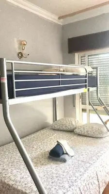 a bunk bed with a hat on the bottom bunk at Beautiful Penthouse Two Bed Roof in Albufeira