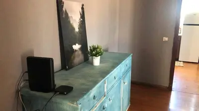a blue dresser with a television on top of it at Beautiful Penthouse Two Bed Roof in Albufeira