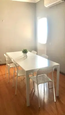 a white table and chairs with a plant on it at Beautiful Penthouse Two Bed Roof in Albufeira