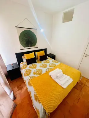 a bedroom with a bed with a yellow blanket at Boutique Two Bedrooms Apartament Praia Da Oura in Albufeira