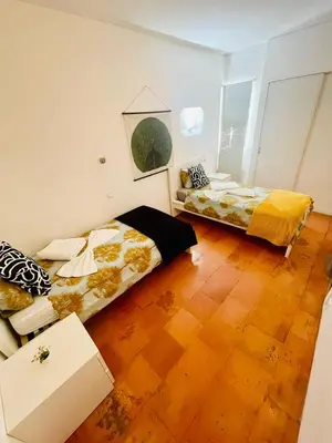 two beds in a room with wooden floors at Boutique Two Bedrooms Apartament Praia Da Oura in Albufeira