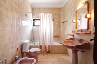 a bathroom with a sink and a toilet and a tub at Villa Luísa Galé in Albufeira