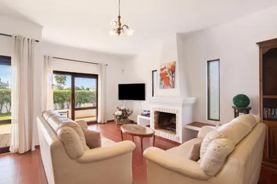 a living room with two couches and a fireplace at Villa Luísa Galé in Albufeira