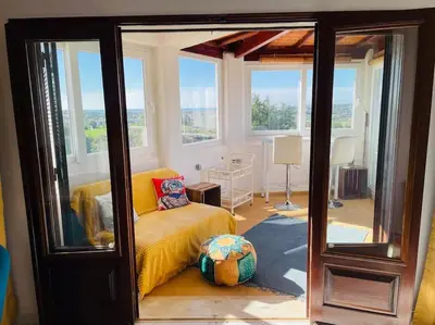 a room with a bed and a room with windows at Self-contained floor of Quinta / Villa in Guia