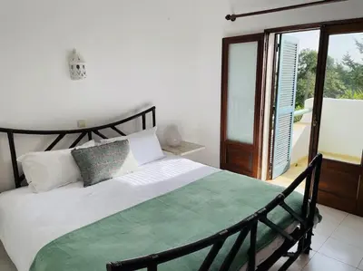 a bedroom with a bed and a large window at Self-contained floor of Quinta / Villa in Guia
