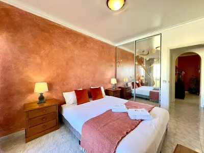 a bedroom with a large bed and a mirror at Albufeira Concept 2 With Pool by Homing in Galé