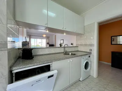 a kitchen with a sink and a washing machine at Albufeira Concept 2 With Pool by Homing in Galé