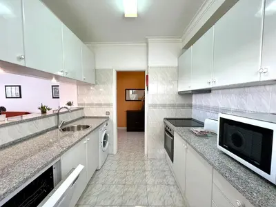 a kitchen with white cabinets and a sink at Albufeira Concept 2 With Pool by Homing in Galé