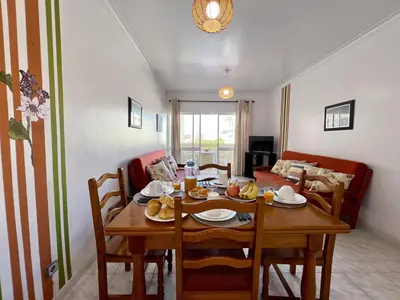 a dining room with a wooden table and chairs at Albufeira Concept 2 With Pool by Homing in Galé