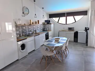 a kitchen with a table and chairs in a kitchen at VILAMOURA APARTMENT NEAR MARINA AND BEACHES in Quarteira