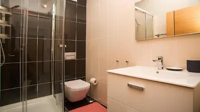 a bathroom with a toilet and a sink and a shower at Apartamento Oura Mar - By Dalma Portuguesa in Albufeira