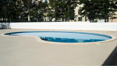 a small pool of water on a sidewalk at Apartamento Oura Mar - By Dalma Portuguesa in Albufeira