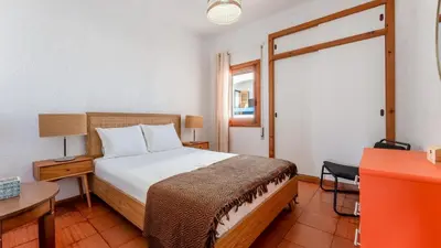 a bedroom with a bed and a desk and a window at Comfy 2 BDR Apartment W/ Balcony by LovelyStay in Albufeira