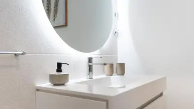 a bathroom with a white sink and a mirror at Comfy 2 BDR Apartment W/ Balcony by LovelyStay in Albufeira