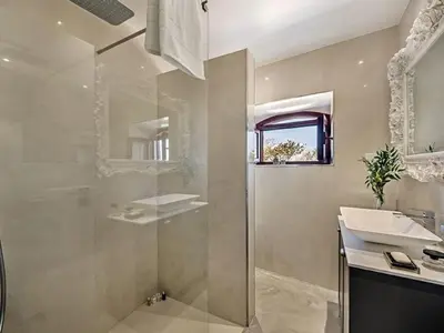 a bathroom with a sink and a shower and a mirror at Villa Recanto Murta V6 VIP Properties by Interhome in Azinhal