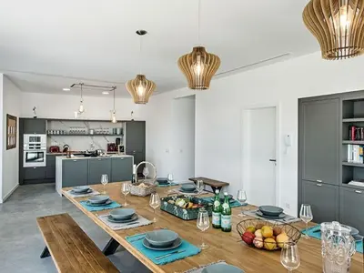 a dining room with a table and a kitchen at Villa Recanto Murta V6 VIP Properties by Interhome in Azinhal