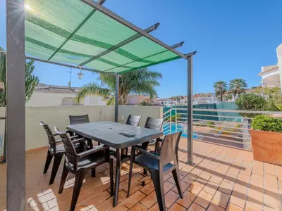 a patio with a table and chairs on a deck at Holiday Home Camélias VIP Properties by Interhome in Albufeira