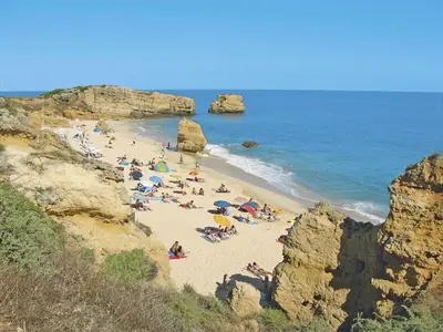 a pool with lounge chairs next to a house at Holiday Home Lima - VIP Properties by Interhome in Albufeira