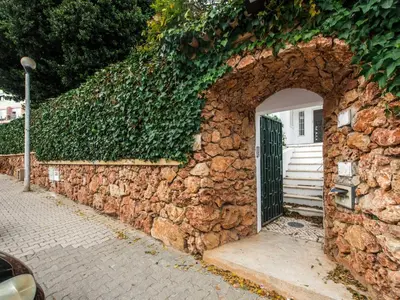 a stone wall with an arch in front of a door at Holiday Home Lima - VIP Properties by Interhome in Albufeira