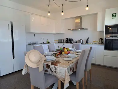 a living room with a white table and chairs at Holiday Home Lima - VIP Properties by Interhome in Albufeira