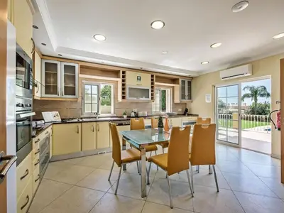 a kitchen with a table and chairs in a kitchen at Villa Monte Sol - VIP Properties by Interhome in Azinhal