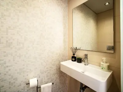 a white bathroom with a sink and a mirror at Villa Pires - VIP Properties by Interhome in Albufeira