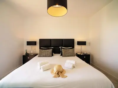 a teddy bear sitting on top of a bed at Villa Pires - VIP Properties by Interhome in Albufeira