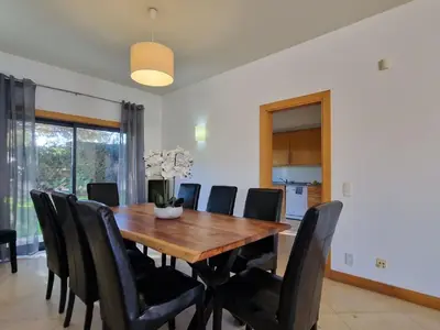 a dining room with a wooden table and black chairs at Villa Corcovada Lote 28 VIP Properties by Interhome in Albufeira
