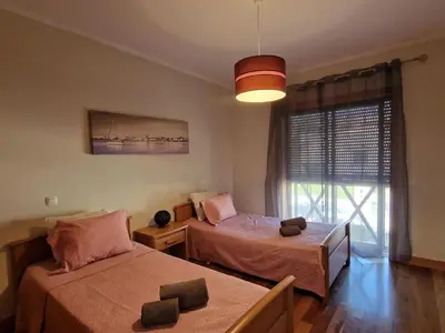 a bedroom with two beds and a large window at Villa Corcovada Lote 28 VIP Properties by Interhome in Albufeira