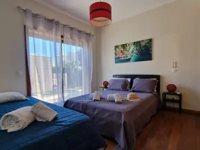 a bedroom with two beds and a large window at Villa Corcovada Lote 28 VIP Properties by Interhome in Albufeira
