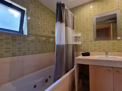 a bathroom with a sink and a tub and a shower at Villa Corcovada Lote 28 VIP Properties by Interhome in Albufeira