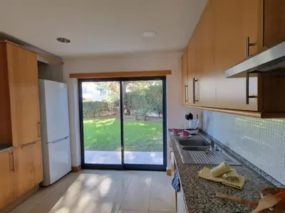 a kitchen with a sink and a door to a yard at Villa Corcovada Lote 28 VIP Properties by Interhome in Albufeira