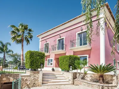 a swimming pool in a yard with palm trees at Villa Quinta Valente VIP Properties by Interhome in Silves