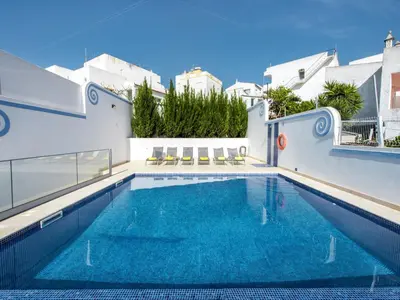 a swimming pool with blue water in a house at Holiday Home Cristal VIP Properties by Interhome in Albufeira