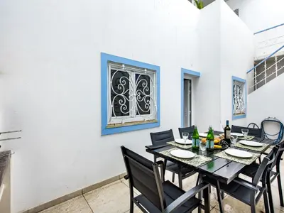 a dining room with a table and chairs and a window at Holiday Home Cristal VIP Properties by Interhome in Albufeira