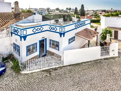 a balcony with a chair and two white lighthouse at Holiday Home Safira - VIP Properties by Interhome in Albufeira