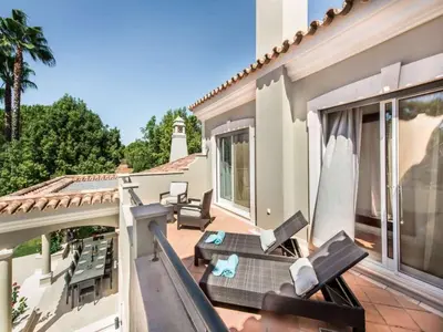 a balcony with chairs and a table on a house at Amazing Algarve Villa 5 Bedrooms Villa Lillian Private Pool & Ping Pong in Almancil