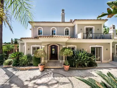 a large white house with plants in front of it at Amazing Algarve Villa 5 Bedrooms Villa Lillian Private Pool & Ping Pong in Almancil