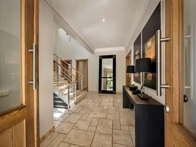 a hallway with a table and a staircase in a house at Amazing Algarve Villa 5 Bedrooms Villa Lillian Private Pool & Ping Pong in Almancil