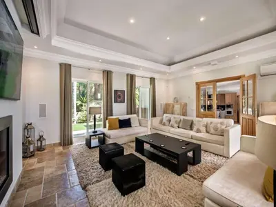 a living room with a couch and a table at Amazing Algarve Villa 5 Bedrooms Villa Lillian Private Pool & Ping Pong in Almancil