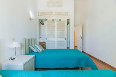 a bedroom with a blue bed and a window at AL - Aldeia do Golfe Retreat in Vilamoura