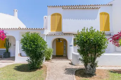 a white house with two trees in front of it at AL - Aldeia do Golfe Retreat in Vilamoura