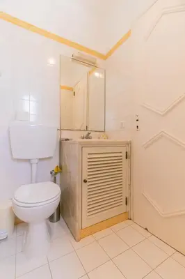 a bathroom with a toilet and a sink and a mirror at AL - Aldeia do Golfe Retreat in Vilamoura