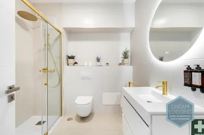 a bathroom with a toilet and a sink and a shower at Moai - Dream Lodging in Albufeira